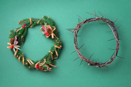 Christmas wreath and crown of thorns on green background. Remember the real Reason of the Season. Christian Christmas and Easter concept. Jesus Christ born to Die, born to Rise. Messiah, Emmanuel.の写真素材