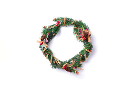Christmas wreath on white background. New year composition. Top view, flat lay. Copy space. Decor for Christmas celebration. Greeting card, minimal conceptの写真素材
