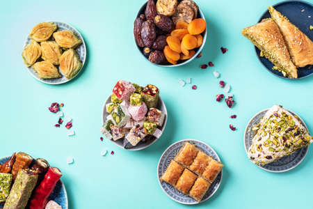 Baklava, halva, rahat lokum, sherbet, nuts, pistachios, dates, raisins, dried apricots, churchkhela. Assorted traditional eastern desserts, arabian sweets, turkish delight. Top view. Flat layの写真素材