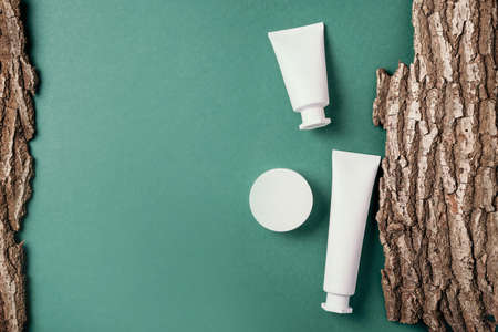 White unlabelled cosmetic bottle on dry wooden bark background. Skin care, organic body treatment, skin nutrition concept. Eco friendly product. Organic cosmetics. Moistening, dry skin conceptの写真素材