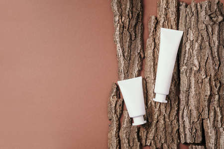 Cream jar, moisturizing lotion, shampoo or other cosmetic product in white blank bottle on beige background. Skin care, skin nutrition. Vegan eco friendly concept. Moistening, dry skin concept.の写真素材