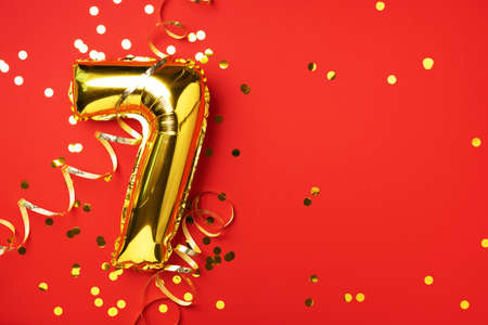 Gold foil balloon number and digit seven 7. Birthday greeting card. Anniversary celebration event....