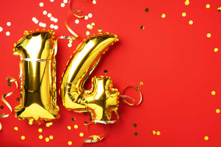 Gold foil balloon number, digit fourteen. Birthday greeting card, inscription 14. Anniversary celebration event. Banner. Stylish golden numeral, bright shiny glitter, red background. Numerical digitの写真素材