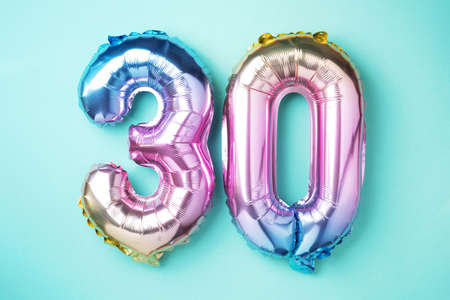 Rainbow foil balloon number, digit thirty. Birthday greeting card with inscription 30. Anniversary...