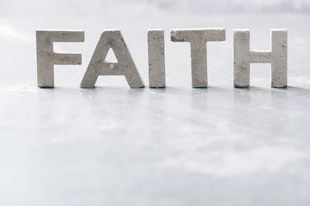Word FAITH made with cement letters on grey marble background. Copy space. Biblical, spiritual or christian reminderの写真素材