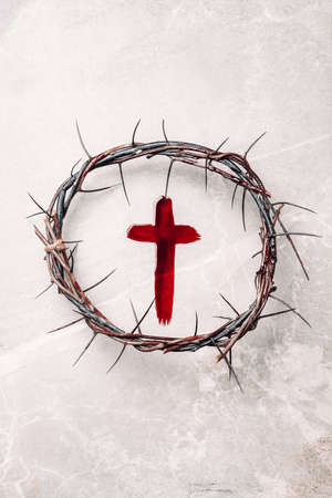 Crucifix made of blood, crown of thorns. Good friday. Easter holiday. Christian cross painted with blood on stone background. Passion, crucifixion of Jesus Christ. Gospel, salvation conceptの写真素材