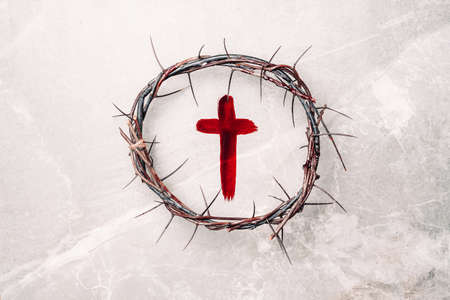 Crown of thorns, cross painted with red blood on stone background. Copy space. Good friday. Passion, crucifixion of Jesus Christ. Christian Easter holiday. Crucifix, gospel, salvation conceptの写真素材