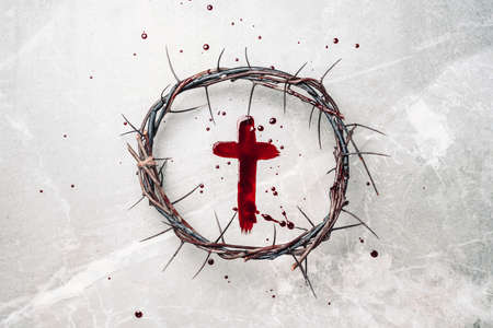 Crucifix made of blood, crown of thorns. Good friday. Easter holiday. Christian cross painted with blood on stone background. Passion, crucifixion of Jesus Christ. Gospel, salvation conceptの写真素材