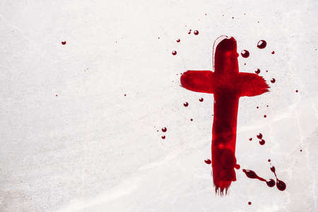 Christian cross painted with red blood on stone background. Copy space. Good friday. Passion, crucifixion of Jesus Christ. Christian Easter holiday. Crucifix, gospel, salvation conceptの写真素材