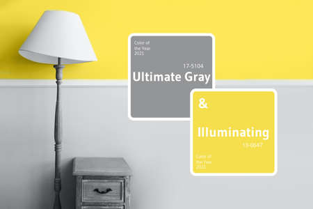 Demonstrating trendy Color of the Year 2021. Illuminating Yellow and Ultimate Gray. Duotone. Floor lamp on pastel wall background. Color Psychology. Minimalistic room interior. Depression treatmentの写真素材