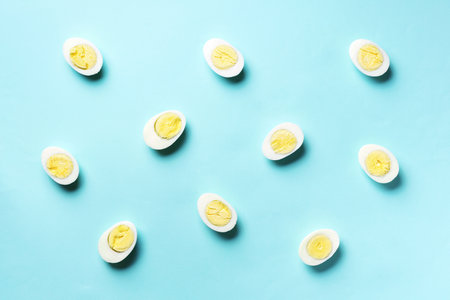 Boiled eggs pattern on blue background. Top view. Creative pattern. Minimal style. Flat lay. Food conceptの写真素材