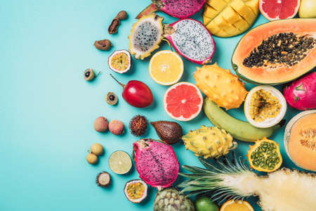 Tropical fruits concept. Exotic fruits - pineapple, papaya, mango, annona, banana, pitahaya, kiwano,...
