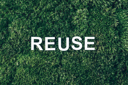 Word Reuse on moss, green grass background. Top view. Copy space. Banner. Biophilia concept. Nature backdropの写真素材