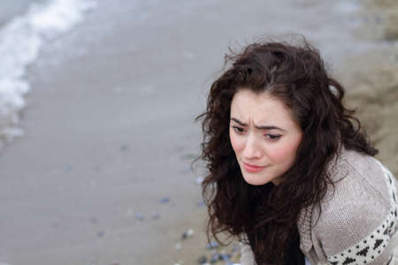girl sad by beach