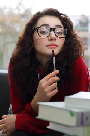 girl with pencil thinkingの写真素材