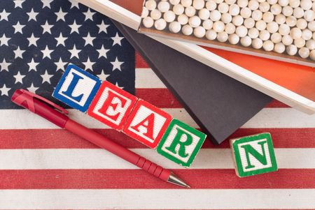 Learn Spelled Out with Books and Pen on American Flagの写真素材