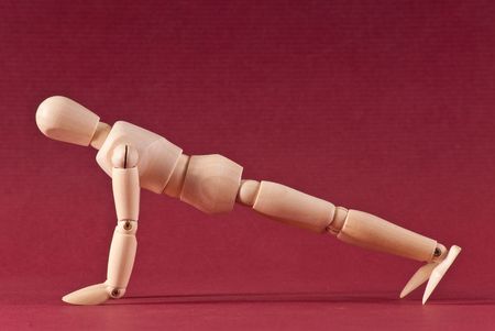 Wooden Art Doll Doing Push Upsの写真素材