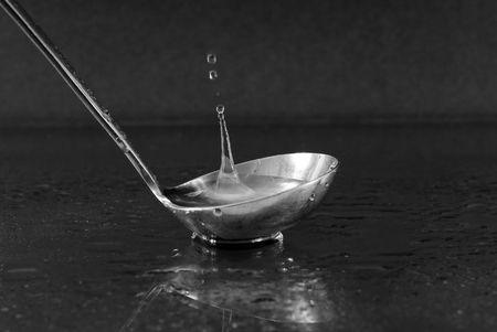 Liquid Splash in Metal Spoonの写真素材