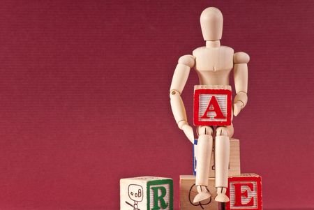 Wooden Art Maniquin Holding Letter A Blockの写真素材