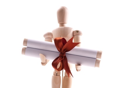 Paper Scroll with Copper Ribbon Held by Art Dollの写真素材