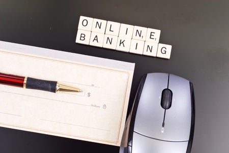 Online Banking Spelled Out with Personal Check and Computer Mouseの写真素材