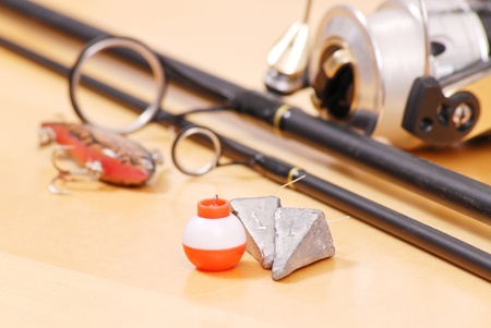 Fishing Weights and Floater Next to Black Fishing Rodの写真素材