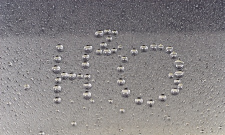 H2O Water Droplet Writing on Glassの写真素材