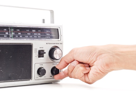 Hand Turning Up the Volume on Vintage AM FM Radioの写真素材