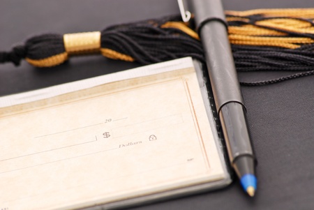 Blank Check with Pen on Graduation Tasselの写真素材