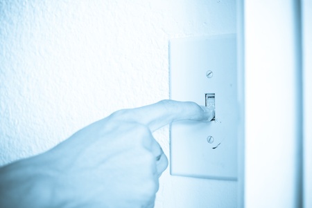 Finger Turning Off Light Switch