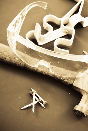Sepia Image of Hand Tools and Safety Glassesの写真素材