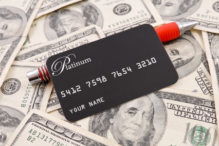 Credit Card with Pen on Pile of Money