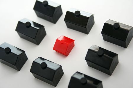 A single red house standing out from the crowd.の写真素材