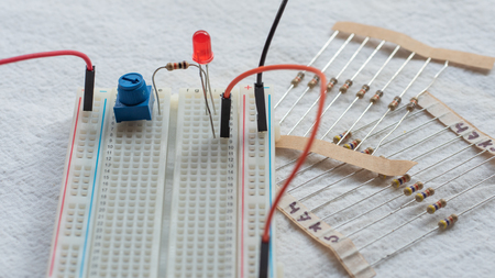 Potentiometer, resistors and red LED set up on a breadboardの写真素材