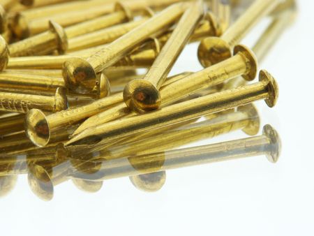 Brass nails reflecting in a mirrorの写真素材