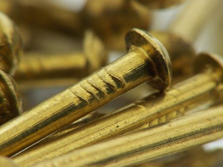 Brass nails reflecting in a mirrorの写真素材