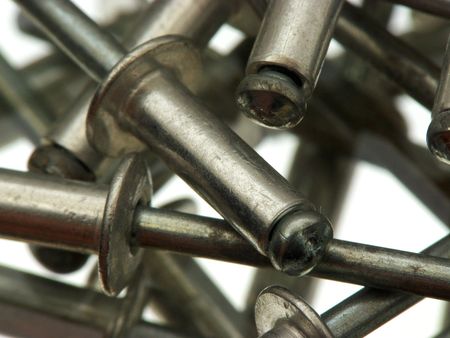 Aluminium pop rivets reflecting in a mirrorの写真素材