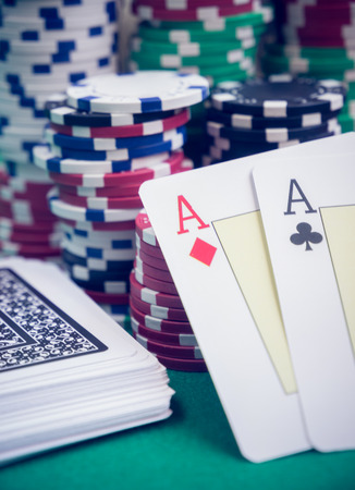 aces pair and with poker chips on green table