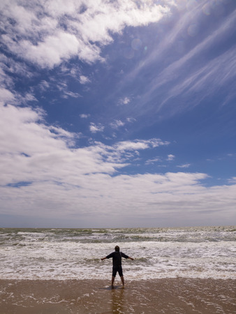 Silhouette of the young man on the beach. Freedom conceptの写真素材