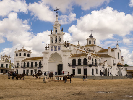 MAY 4, 2.017. Almonte, Huelva, Andalusia, Spain. Hermitage of El Rocio reflected in the water with clouds in the blue sky. Place of Christian pilgrimage in an annual pilgrimageのeditorial素材