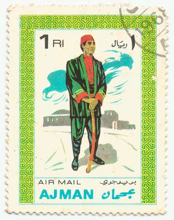MERIDA, EXTREMADURA, SPAIN. DIC, 01, 2.108 - A stamp shows the typical clothes of peolpe of Ajman, city of Emirates Arab United . CIRCA: 1.968のeditorial素材