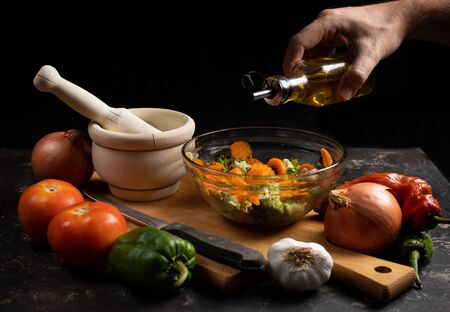 preparing salad with carrots, broccoli and cauliflowerの写真素材