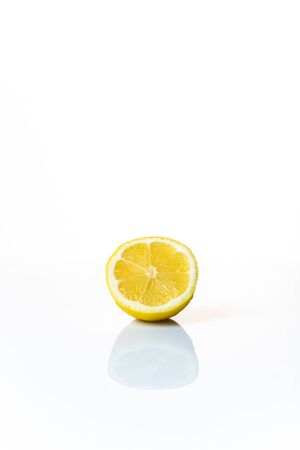 half a lemon isolated on a white background with space for textの写真素材