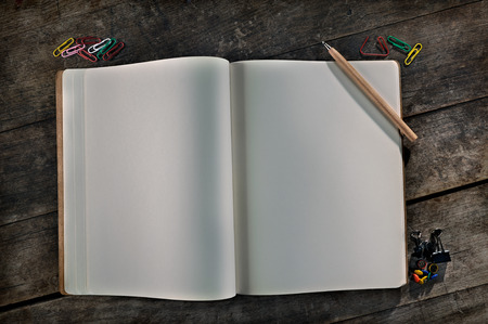 Blank vintage notebook with pencil and paper clips, it can be easily customized with any text の写真素材