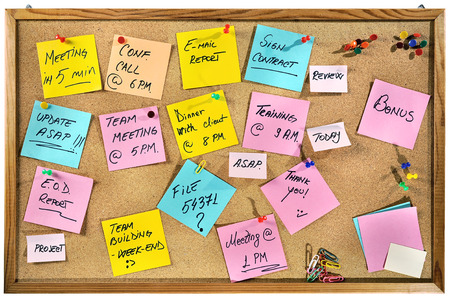 Corporate words written on paper notes on a cork message board の写真素材