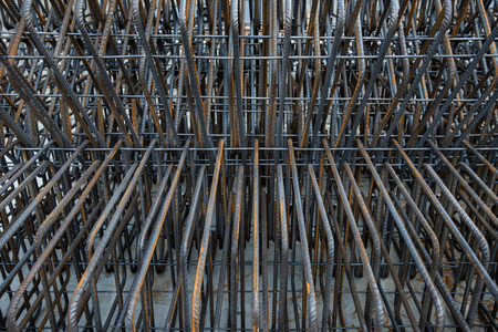 Artistic steel bars closeup, reinforcement on construction site, editable background. Steel bars or rods, formwork used on construction sites for concrete layering.の写真素材