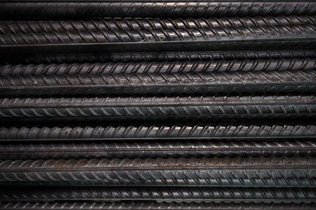 Artistic steel bars closeup, reinforcement on construction site, editable background.Steel bars or rods used on construction sites for concrete layering.の写真素材