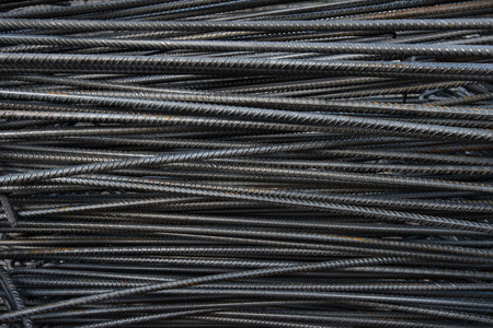Artistic steel bars closeup, reinforcement on construction site, editable background. Steel bars or rods used on construction sites for concrete layering.の写真素材