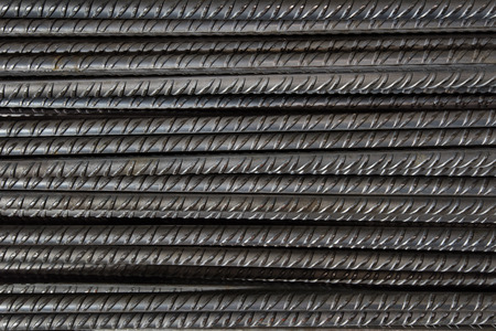 Artistic steel bars closeup, reinforcement on construction site, editable background. Steel bars or rods used on construction sites for concrete layering.の写真素材