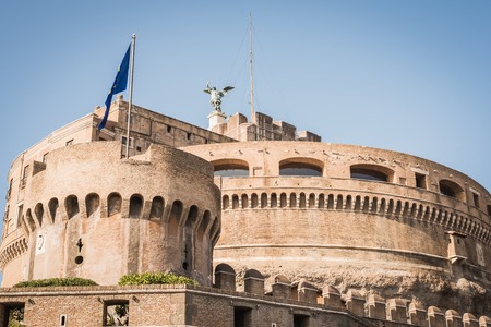 Historic castle of Rome on a blue sky with the European flag Italy